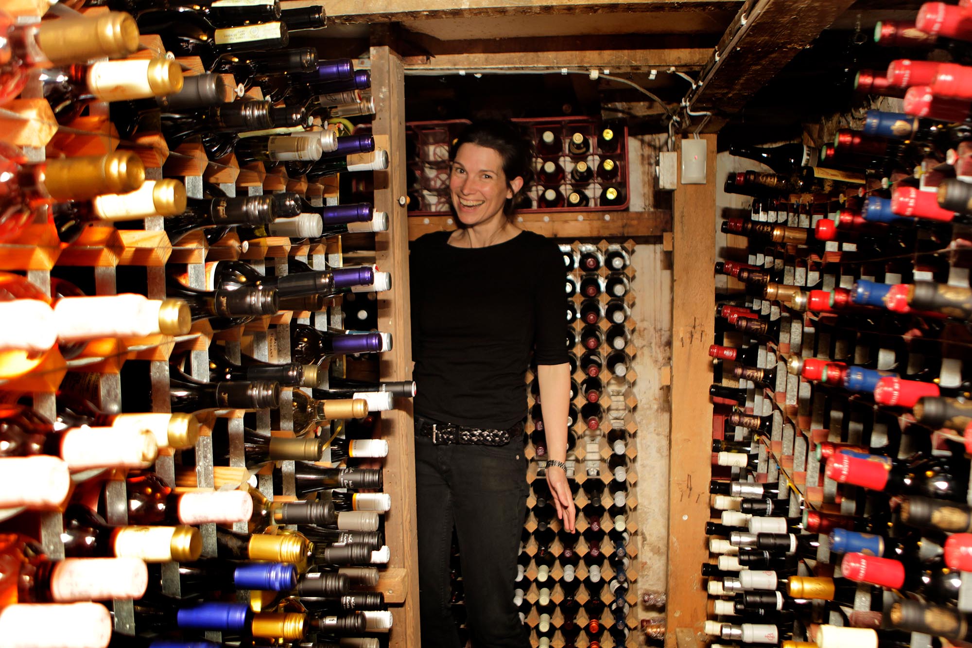Close up of wine bottles in rack.